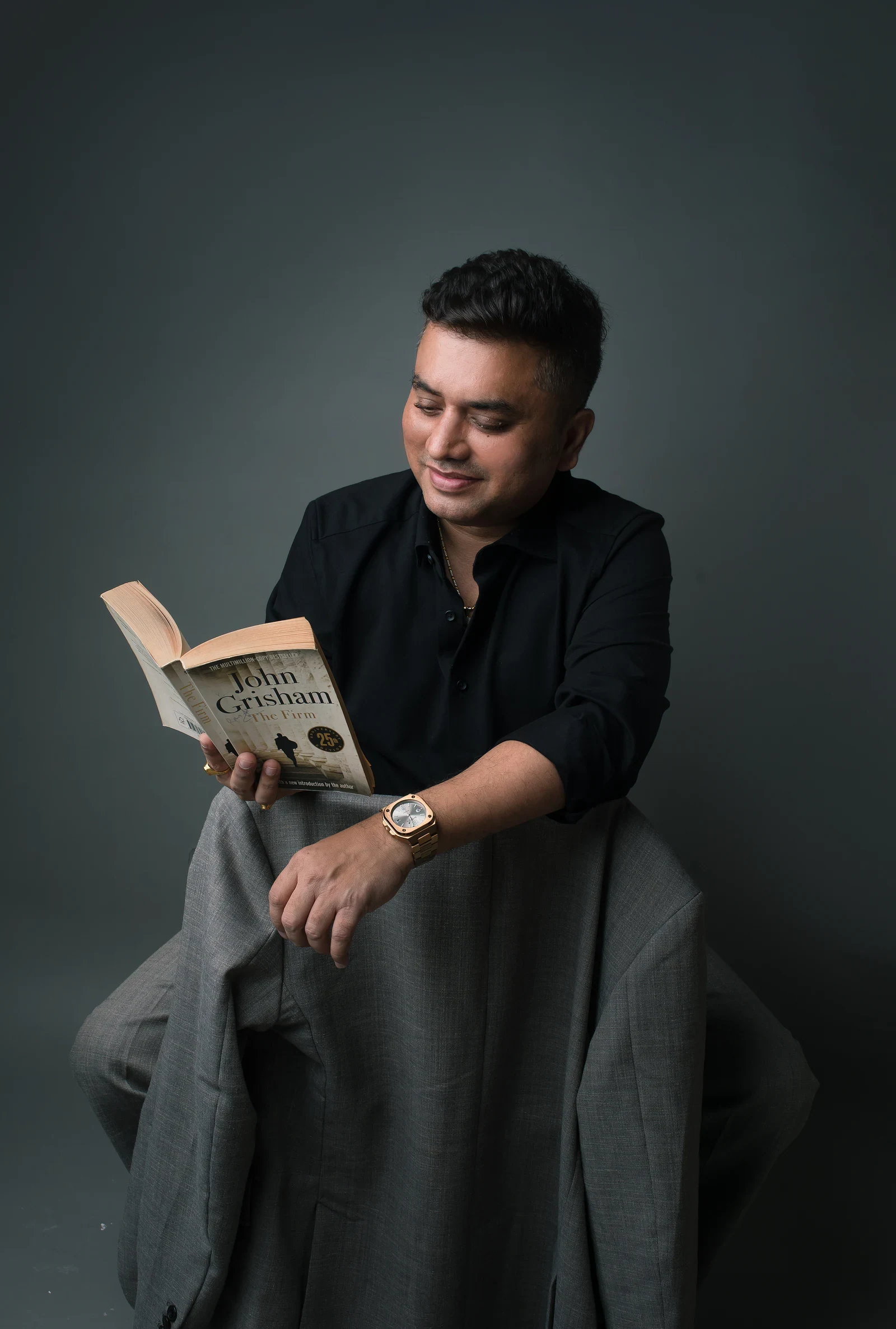 Vipul Joshi seated reading a book
